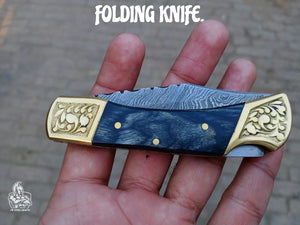 Folding pocket knife with color wood handle.