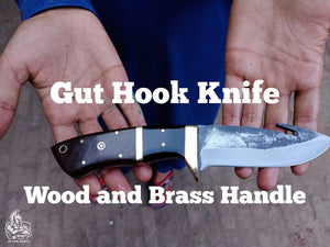 Gut hook knife with wood and brass handle.